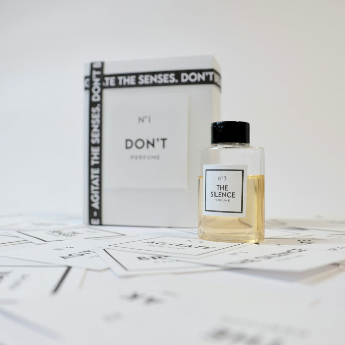 a bottle of perfume sitting next to a box