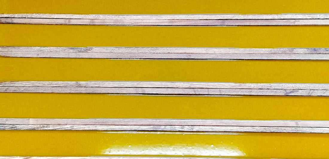 a group of wooden sticks sitting on top of a yellow table