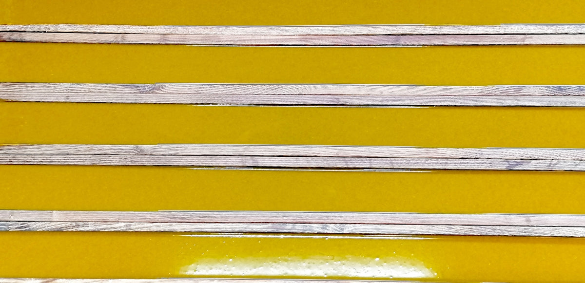 a group of wooden sticks sitting on top of a yellow table