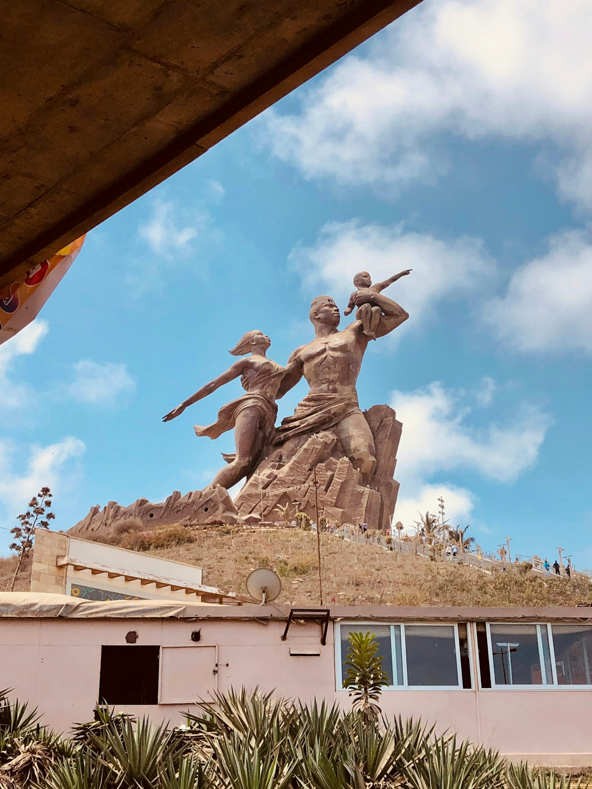 a statue of two men with guns on top of a building