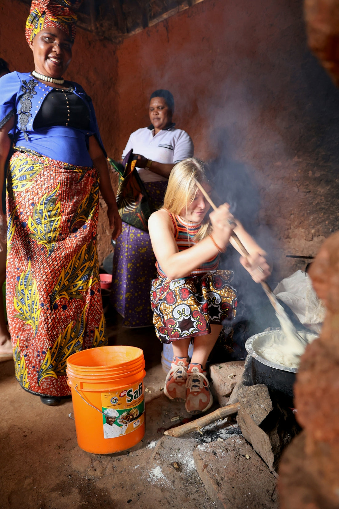 A group of women cooking food over a fire