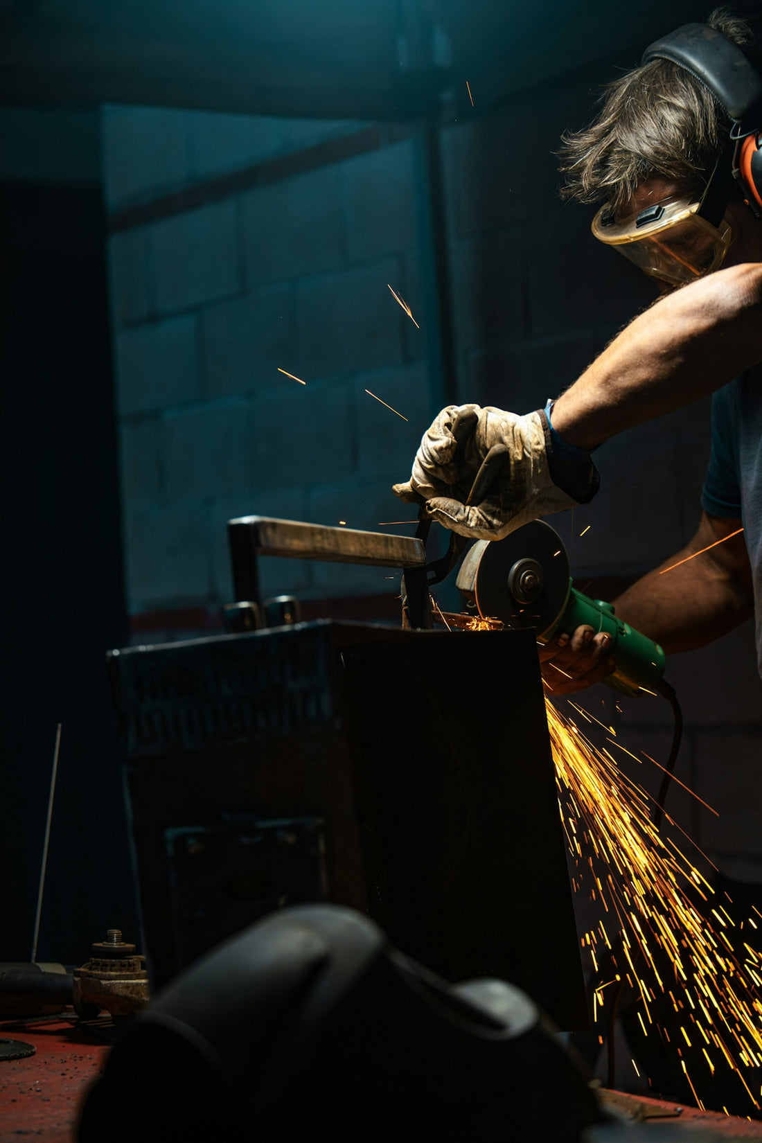 A man working with a grinder in a factory
