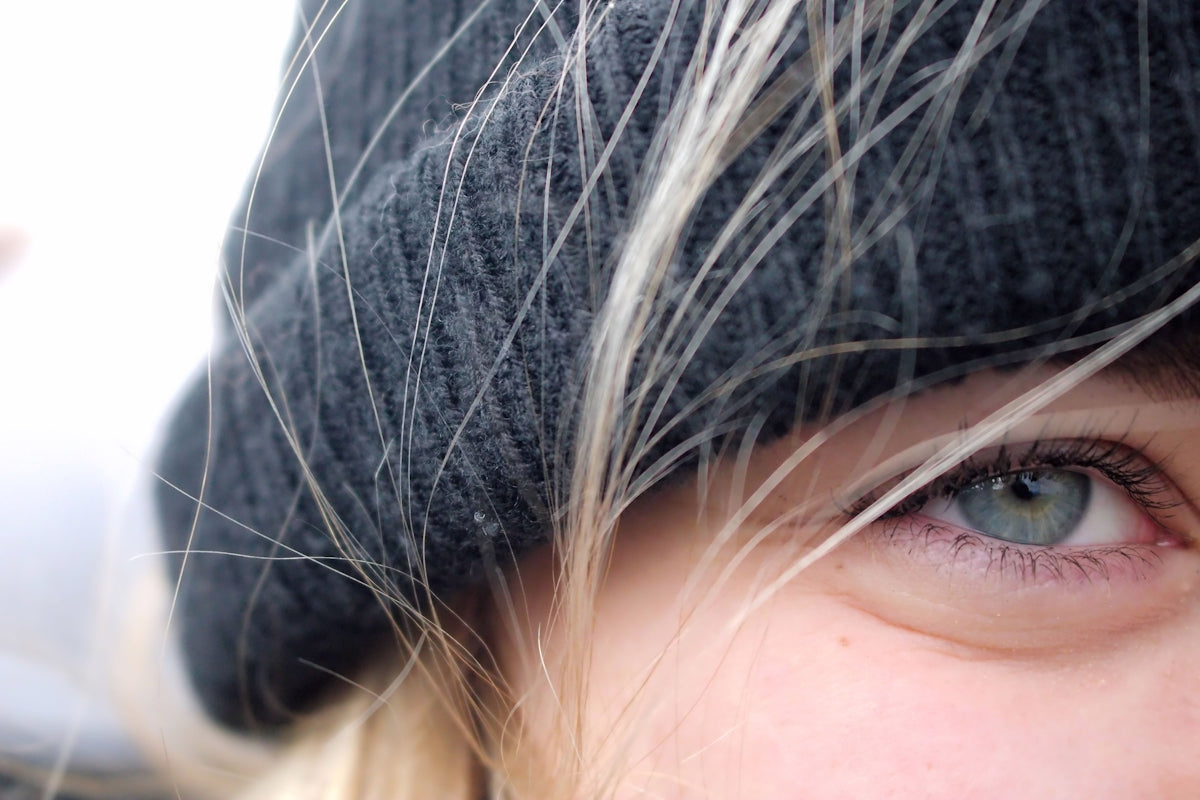 A close up of a person wearing a hat