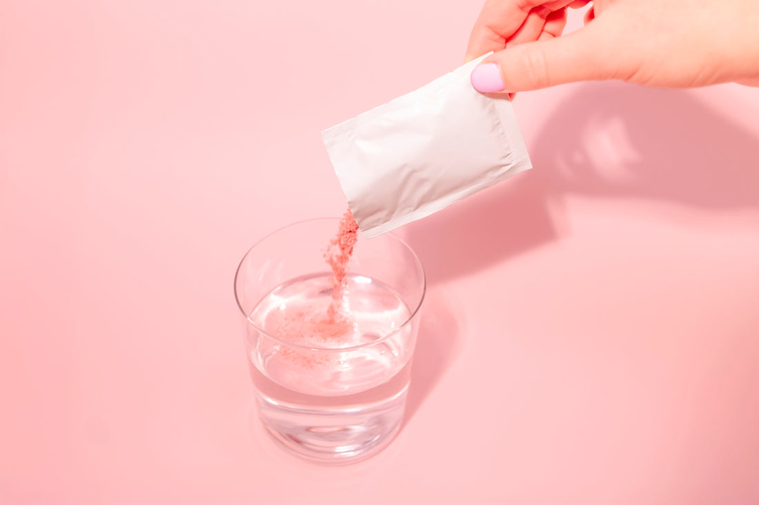 A person pouring a drink into a glass