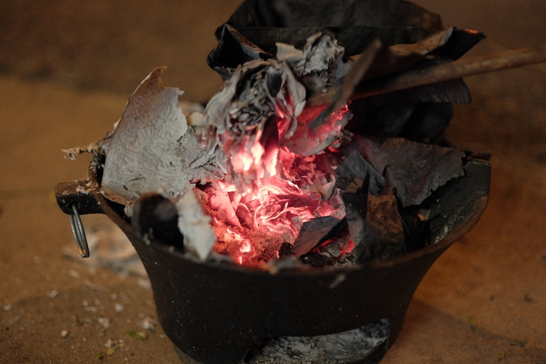 A pot with a fire inside of it on a table