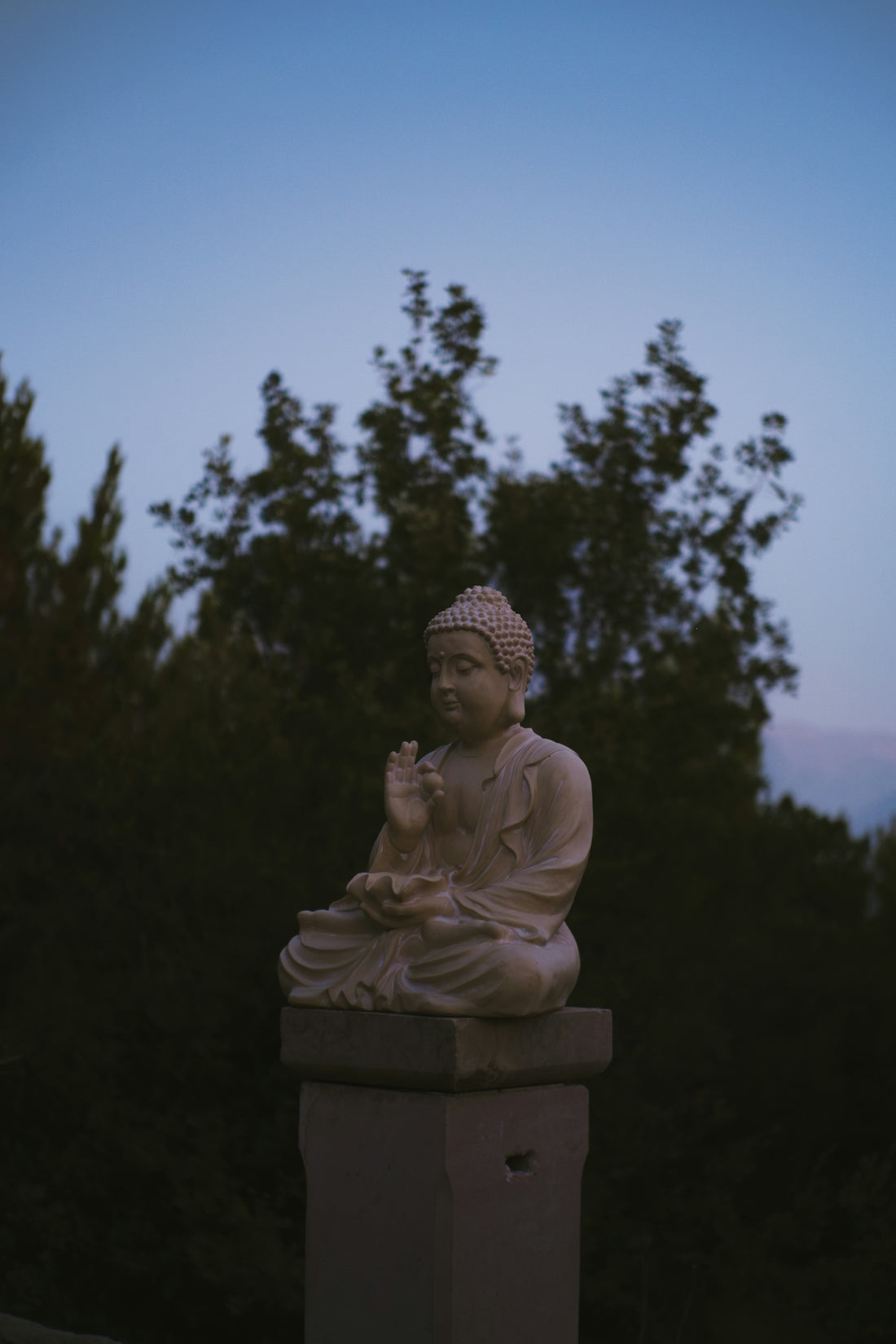 Buddha statue sits peacefully at dusk